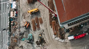 Construction cranes and excavators machinery working in development on construction site. hyperlapse timelapse time lapse Construction And Development Business. Elevated View construction site area