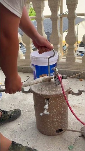 The process of applying paint to a fence with Roman columns