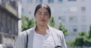 business woman reading text messages on her phone and holding a coffee outside in the city. Latino corporate professional walking to work. Happy, confident and leading woman winking and texting