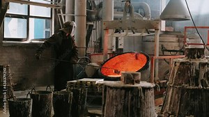 Steelmaker works in a foundry. Liquid metal in furnace. Liquid metal production process. Molding molten metal at industrial plant. Iron And Steel Works.