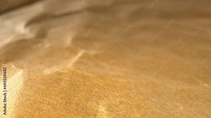 Moving right over flattened interior of recycled shipping envelope, focused on bottom of screen. Fibers and textures in material seen, looks like a topographical map with contours and bumps.