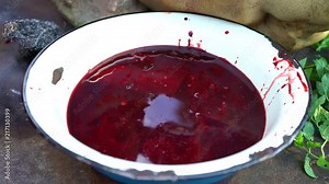 Pig slaughter. The blood of a pig in a bowl, close-up.