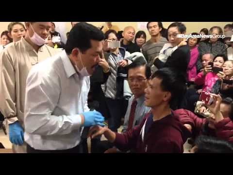 Spiritual healer, Vo Hoang Yen, helps Vo Loi, 57, with his deafness at the Tam Tu Buddhist Temple in
