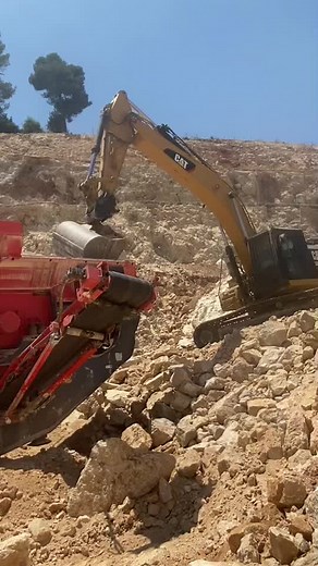CAT Excavator in Action: Rock Moving Techniques