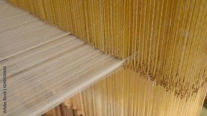 Close up shot of a manual loom powered for textile production as part of a weaving process