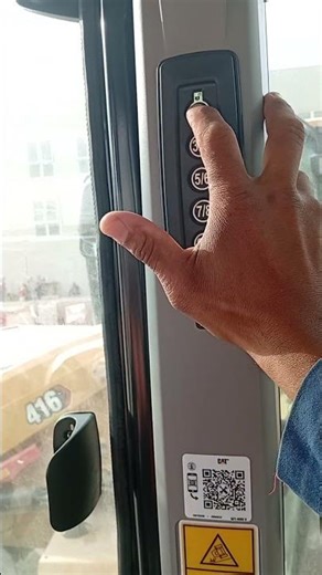 How to set a password for a Caterpillar backhoe loader.