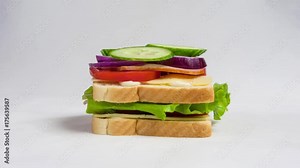 Time lapse of making a big sandwich with tomato, ham, cheese and salad. Stop motion of preparing snacks