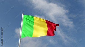 Flag of Mali on a blue sky, flag on a flag pole waving in the wind, african country, national symbol of Mali, video of a flag