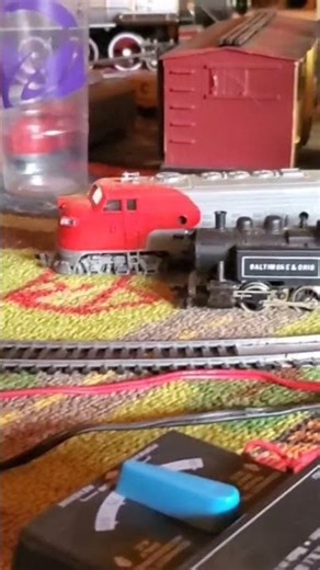 HO gauge train Chessie engine, Union Pacific coal car, B and O caboose.