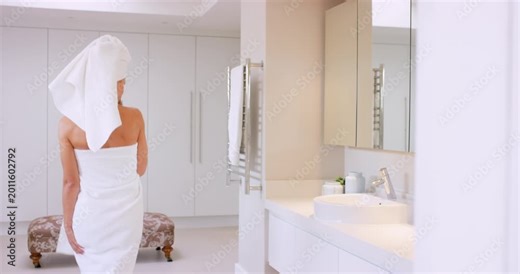 Bathroom, woman and singing with brush in home for self care, haircare and fun energy in mirror. Female person, karaoke and dancing in house with towel for hygiene, grooming and wellness in morning
