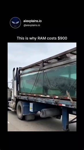 𝖺𝗂𝖾𝗑𝗉𝗅𝖺𝗂𝗇𝗌.𝗂𝗈 on Instagram: "The video captures a flatbed truck navigating a highway while transporting a large alligator secured in a transparent, water-filled tank approximately 20 feet long, restrained by heavy chains and supported by a metal frame to prevent shifting during transit. This imagery functions as a clever visual pun to illustrate the economic pressures on computer random access memory (RAM), where prices for high-bandwidth modules have climbed to around $900 due to su