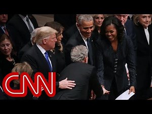 Michelle Obama, George W. Bush share warm moment at funeral