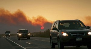 Alaska wildfires destroy dozens of homes, menace highway