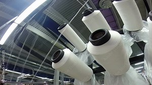 Threads and Spools in Textile Factory / Small group of threads and spools on a weaving and warping machine in a textile mill HD1080p