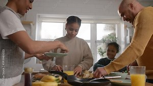 Family and boy with Down syndrome making pancakes for breakfast