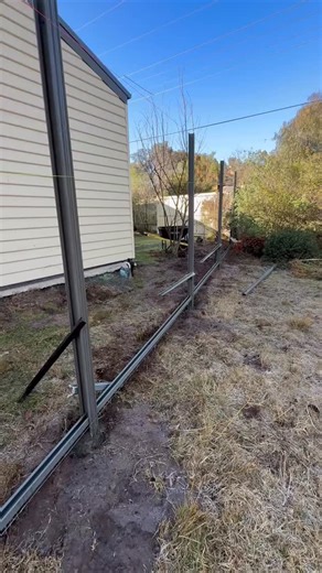 Slopped Colorbond Woodland Grey fence. #colorbond #colorbondsteel #colorbondfence | Rctichuntres Kennels