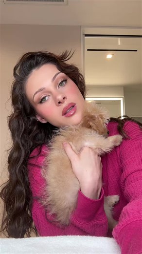 Adorable Puppy Cuddles with Woman in Pink Sweater
