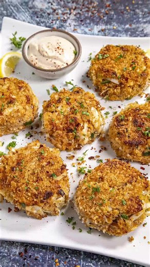 These crab cakes are easy to make, loaded with lump crab meat, so tender with a crispy coating, drizzled with homemade creamy crab cake sauce, always a hit. Learn how to make crab cakes. Ingredients: 1 cup panko breadcrumbs divided (or use bread crumbs or crushed saltine crackers) 2 teaspoons Cajun seasoning or more to taste 1 tsp garlic powder Salt and pepper to taste 2 eggs beaten 1/4 cup mayonnaise (I prefer Duke's) 1 tablespoon of your favorite hot sauce 1 tablespoon whole grain mustard 1 te