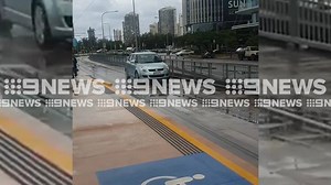 #WATCH: The moment a confused driver cruises down the tram tracks at Southport has been caught on camera. #9News | http://9News.com.au | 9 News Gold Coast