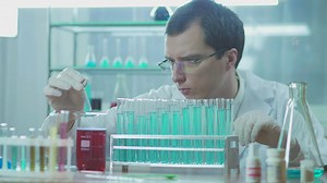 A scientist experimenting with tubes on the lab - Free Stock Video