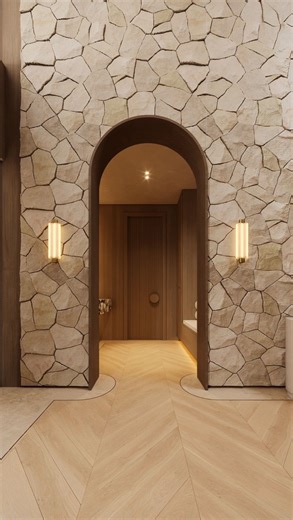 Boutique interior & architectural design studio on Instagram: "Because your first step inside matters The entrance to our mudroom flows seamlessly through a stone archway, catching a warm, inviting glow from the entryway. This custom space is designed for ultimate functionality. It features a stunning marble console with an oversized LED mirror and a versatile 3-in-1 built-in: a designer bench upholstered in elegant bouclé, integrated shoe storage below, and a dedicated closet with extra hooks f