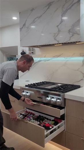 Demonstrating the spice drawer in this IKEA kitchen with Swedish Door fronts
