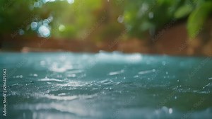 Dripping water droplets are streamed with a macro lens into a puddle. in Slow Motion 4K