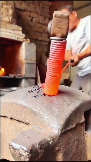 Turning a red-hot spring back into straight wire!