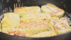 Chef sprinkles sesame seeds on halloumi cheese. Halloumi cheese frying in a pan.