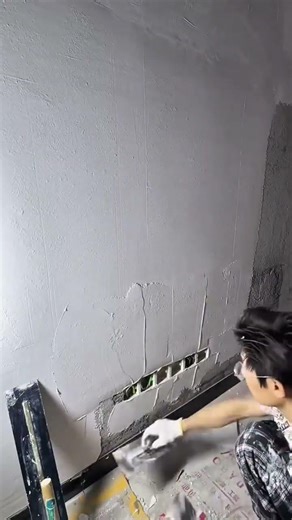 Smoothing Cement Walls Using A Metal Spatula To Create Neat And Even Finishes In Building Interiors