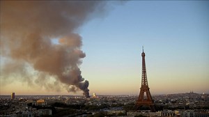 Paris fire visible in skyline as 180 firefighters fight the flames