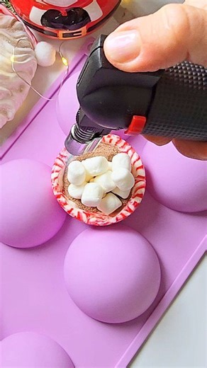 Peppermint Candy Hot Cocoa Bomb!🍬☕️ It's for all my peppermint and candy cane lovers! Works great as treat, gift, or even as decor 🎄 Directions: Preheat the oven to 175 F. Place 5 peppermints into the sphere mold closely together as shown on video. Place the mold onto baking sheet, and bake on the middle rack for 10 minutes. Remove from oven and carefully squeeze together the peppermints just so there are no holes. Add the second layer of 7 peppermints and bake for additional 10 minutes. Remov