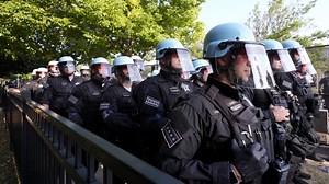 Some protesters tear down security fence as thousands march outside Democratic National Convention