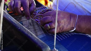 Close-up of hands weaving the tapestry with diverse bright threads on a classic Asian loom at work. Traditional hand weaving of the mountain tribes of northern Thailand. Stock Video