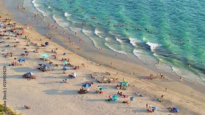 Nokomis, Florida. Sandy beach in Sarasota county, USA. Many people enjoying vacation time bathing in warm gulf water and tanning under hot sun at sunset