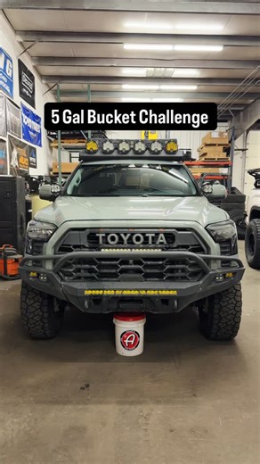Runnin 4 Tacos on Instagram: "Ground clearance test using a 5 gallon bucket. The lunar rock colored Tundra has a 2.5-inch lift and 37-inch @toyotires RT Trail tires. The Tundra hits the bucket at the engine skid plate and needs about 2 inches to clear it. The white colored Tundra has the @74weld portal kit, lifted 3-inches taller than the lunar rock Tundra, and 40-inch tires. This Tundra easily clears the bucket with a few inches to spare."