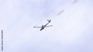 Jet-powered Sailplane Glider Descending In The Sky During Aerobatic Display. low angle, tracking shot