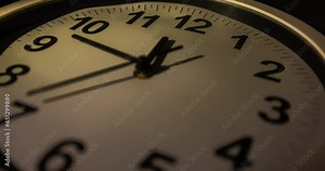 Clock face time lapse on white background with copy space for your own text. Clock time ticking on a classic Wall Clock. Shadows moving over the Watch. Half of a Clock dial close-up isolated. Concept