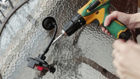 clip-3963758271-woman-using-cordless-power-screwdriver-remove-screw