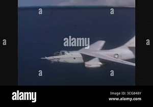 UNITED STATES - 1967 - A Douglas A-3 Skywarrior aircraft in flight, showing the cockpit and fuselage of the aircraft. The aircraft banks away from the camera.