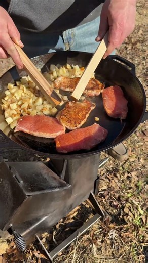 Off grid cabin cooking on a rocket stove with real wood fire.