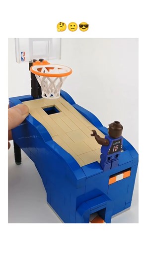 Flame Hole on Instagram: "The post shares a 23-second video timelapse of hands assembling a compact Lego basketball setup, featuring a mini court, hoop, orange basketballs, gold coins as rewards, and a brown minifigure in a blue jersey numbered 15 attempting a shot, evoking satisfying build aesthetics. Posted on February 9, 2026, by @Onein2four_ —a user encouraging mutual follows—it quickly amassed 651,000 views, 5,600 likes, and 514 replies, mostly Indonesian comments praising its cuteness and 