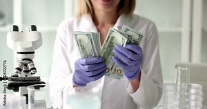 Scientist doctor considers dollar banknotes under microscope in lab. Forensic medical examination Stock Video