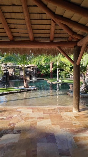 This tropical backyard oasis in Weston, Florida, is one of our favorites! The combination of an Ipe wood deck, natural rock, and lush tropical landscaping creates a timeless paradise that looks like it’s been here forever. We used large, mature specimen plants to give it that instant, established feel, no waiting years for it to grow in. #InsanePools #LucasLagoons