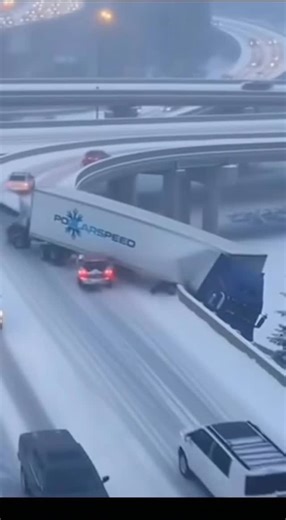 Jane Hodges on Instagram: "Witness a chilling recreation of a severe winter road incident on an elevated highway bridge. This intense, photorealistic simulation captures a chaotic multi-car pileup unfolding amidst heavy snowfall and foggy night conditions. From a static, overhead aerial perspective, the scene shows a large blue "Polaris" logo semi-truck, fully overturned and blocking multiple lanes, setting the stage for disaster. The simulation meticulously details the moments leading to and du