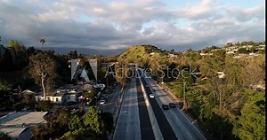 Aerial crossing the Freeway-110 Highway in Los Angeles, empty with almost no cars during the lockdown of Coronavirus pandemic. Drone view Mount Washington to Highland Park and the Arroyo Seco Park