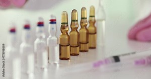 Doctor pharmacist taking medicine ampoule with syringe for intravenous injection closeup 4k movie slow motion. Vaccination and immunization concept