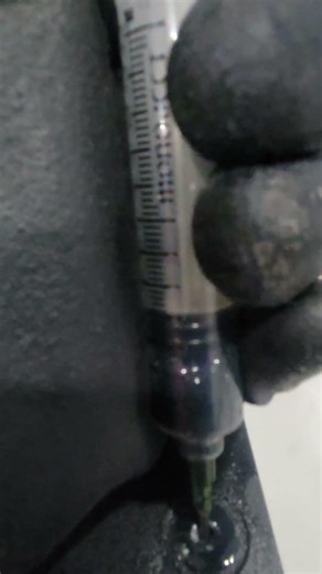 using a syringe to suck out waste material