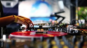 Hip hop dj girl playing music on party.Professional female disc jockey mixes musical tracks with retro turntables & sound mixer panel.Vintage analog vinyl records with rap music on concert stage