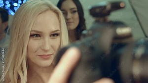 Model looking at her pictures on the camera's screen in the studio after shooting